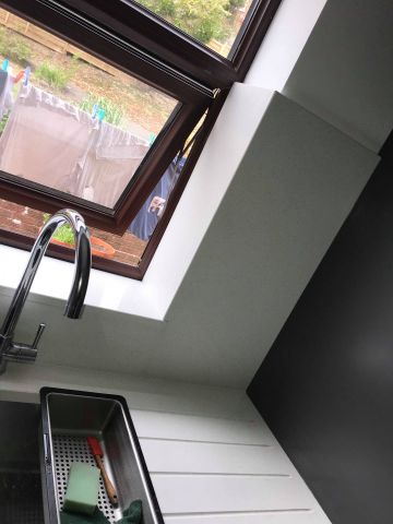 White composite quartz worktops and wall cladding